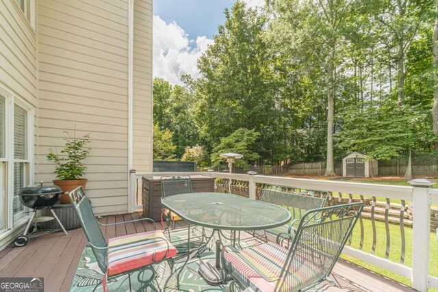 1461 Radstone Dr, Lawrenceville, GA 30044 - wooden deck with a shed, outdoor dining area, and a fenced backyard