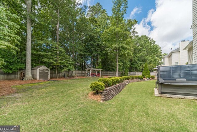 1461 Radstone Dr, Lawrenceville, GA 30044 - fenced backyard featuring a hot tub, a storage shed, and view of wooded area