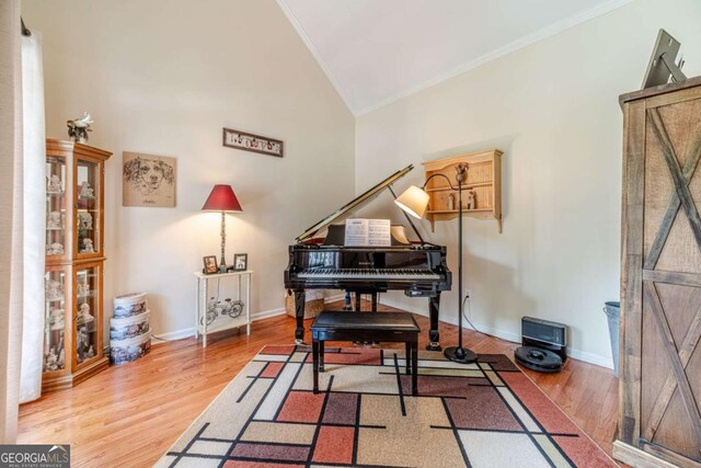 1461 Radstone Dr, Lawrenceville, GA 30044 - sitting room featuring crown molding, vaulted ceiling, and light wood-style flooring