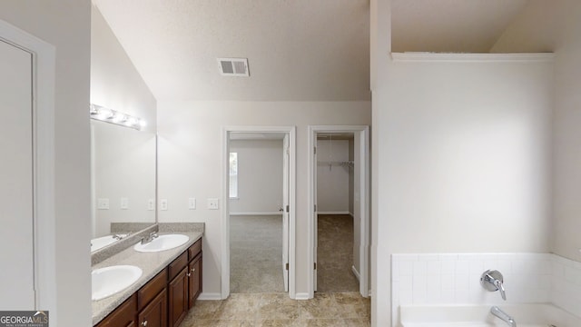 1001 Balsam Wood Trl, Villa Rica, GA 30180 - bathroom with double vanity, a garden tub, a spacious closet, and tile patterned flooring