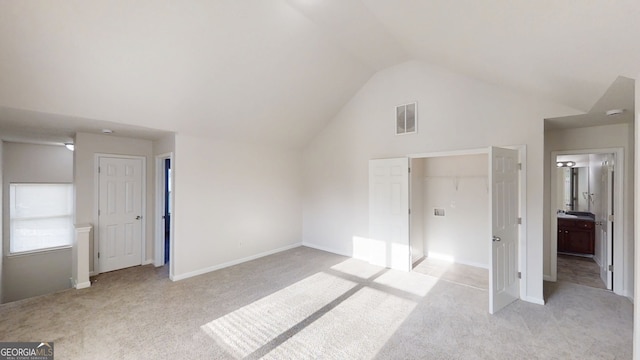 1001 Balsam Wood Trl, Villa Rica, GA 30180 - unfurnished bedroom with light carpet, vaulted ceiling, and ensuite bath