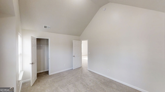 1001 Balsam Wood Trl, Villa Rica, GA 30180 - unfurnished bedroom featuring lofted ceiling, light carpet, and a closet