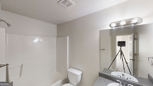 1001 Balsam Wood Trl, Villa Rica, GA 30180 - bathroom with a textured ceiling,  shower combination, and vanity