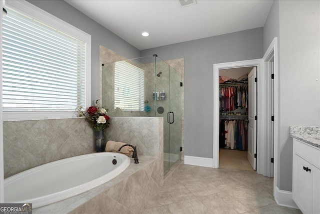 112 Sterling Lake Way, Jefferson, GA 30549 - full bathroom with a bath, vanity, a shower stall, tile patterned floors, and a spacious closet