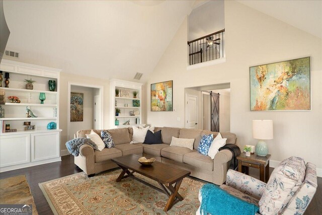 112 Sterling Lake Way, Jefferson, GA 30549 - living room featuring high vaulted ceiling, dark wood-style flooring, and built in shelves