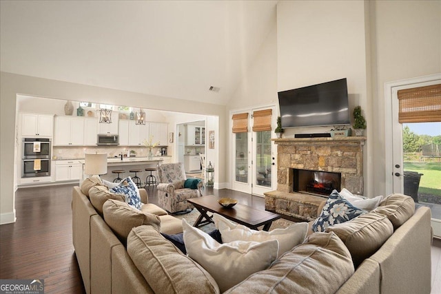 112 Sterling Lake Way, Jefferson, GA 30549 - living room featuring high vaulted ceiling, dark wood finished floors, and a stone fireplace