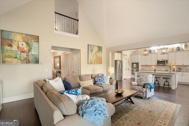 112 Sterling Lake Way, Jefferson, GA 30549 - living room featuring dark wood-style floors, high vaulted ceiling, and a chandelier