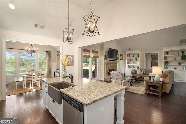 112 Sterling Lake Way, Jefferson, GA 30549 - kitchen with dishwasher, a chandelier, a stone fireplace, dark wood-style floors, and a kitchen island with sink