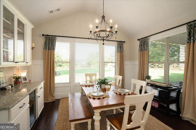 112 Sterling Lake Way, Jefferson, GA 30549 - dining area with a chandelier, a wainscoted wall, vaulted ceiling, a decorative wall, and dark wood-type flooring
