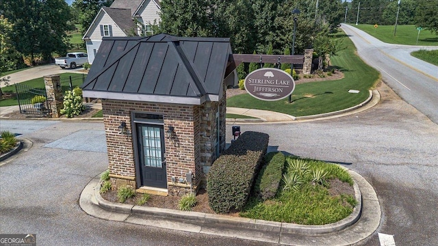 112 Sterling Lake Way, Jefferson, GA 30549 - exterior view of brick siding, a standing seam roof, and a metal roof