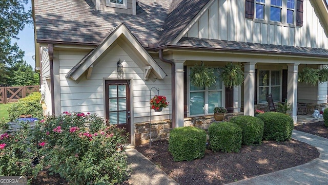 112 Sterling Lake Way, Jefferson, GA 30549 - doorway to property featuring a porch, board and batten siding, stone siding, and a shingled roof