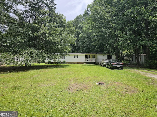 74 Holly Dr, Carrollton, GA 30116 - view of front facade featuring a front yard and dirt driveway
