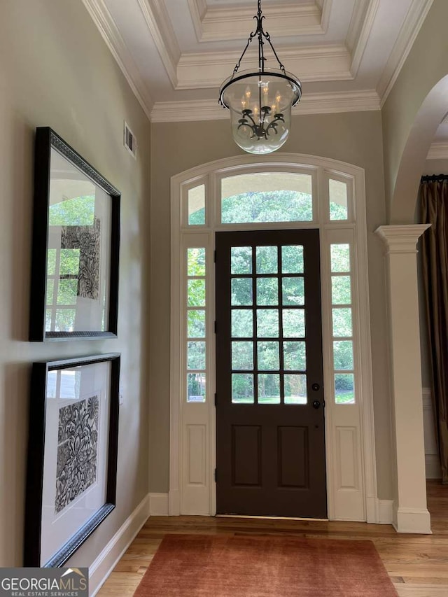 605 Meadows Creek Dr, Johns Creek, GA 30005 - foyer entrance with a chandelier, light wood finished floors, arched walkways, crown molding, and a raised ceiling