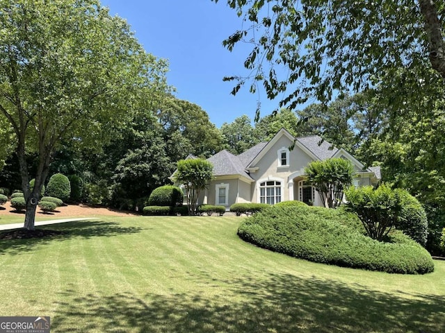 605 Meadows Creek Dr, Johns Creek, GA 30005 - view of property exterior featuring a lawn and stucco siding