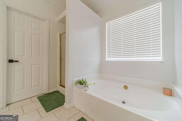 2895 Dominion Walk Ln, Snellville, GA 30078 - full bath featuring tile patterned flooring, a bath, and a stall shower