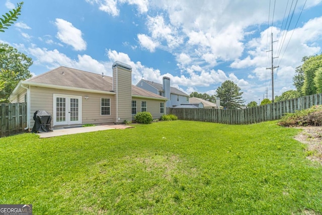2895 Dominion Walk Ln, Snellville, GA 30078 - back of house with french doors, a patio, a fenced backyard, and a chimney