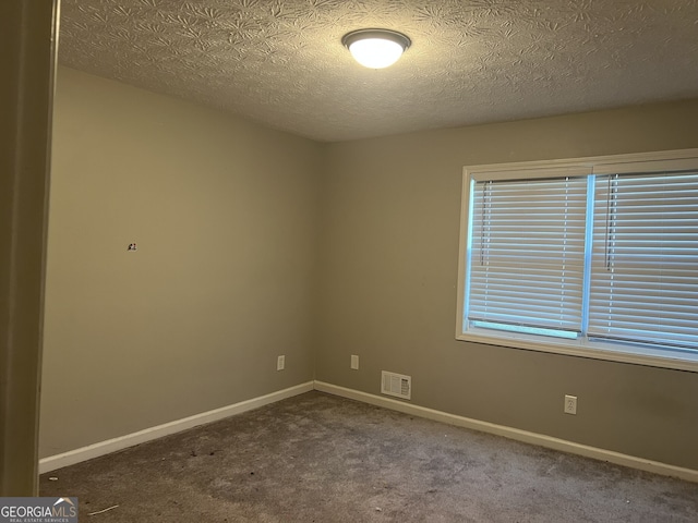 1701 Charmeth Rd, Lithonia, GA 30058 - carpeted spare room with baseboards and a textured ceiling