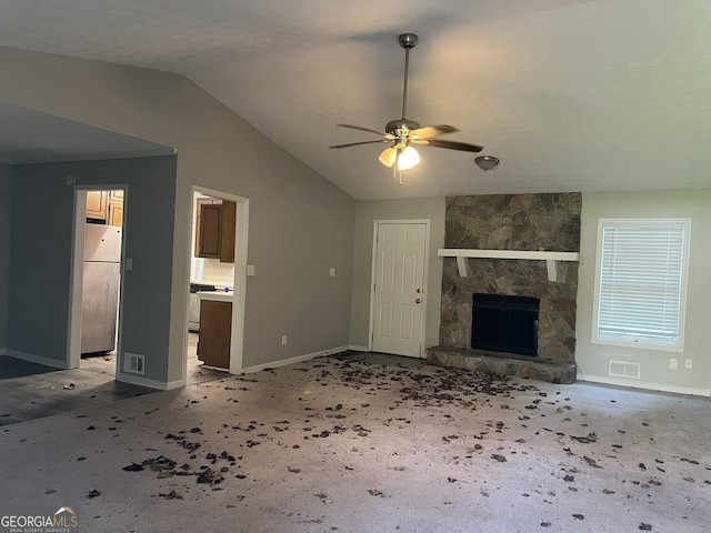 1701 Charmeth Rd, Lithonia, GA 30058 - unfurnished living room featuring a ceiling fan, vaulted ceiling, and a fireplace