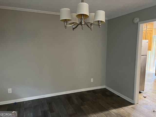 1701 Charmeth Rd, Lithonia, GA 30058 - spare room featuring ornamental molding, a chandelier, wood finished floors, and a smoke detector