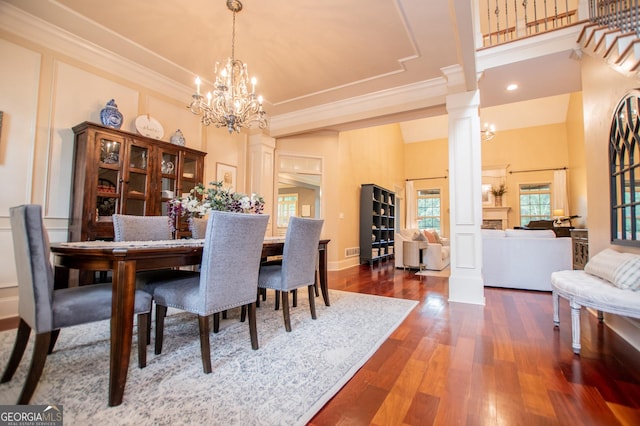 713 Birkdale Blvd, Carrollton, GA 30116 - dining room with ornate columns, a towering ceiling, dark wood-style floors, ornamental molding, and a chandelier