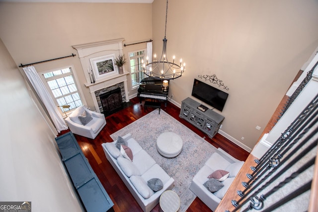 713 Birkdale Blvd, Carrollton, GA 30116 - living room with a towering ceiling, a chandelier, a high end fireplace, and wood finished floors