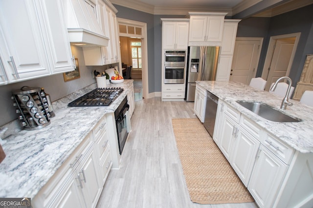713 Birkdale Blvd, Carrollton, GA 30116 - kitchen with appliances with stainless steel finishes, custom range hood, light wood-style flooring, crown molding, and white cabinets