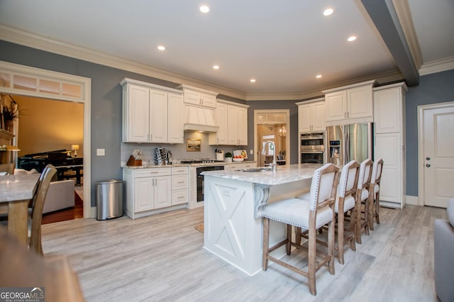 713 Birkdale Blvd, Carrollton, GA 30116 - kitchen featuring beverage cooler, stainless steel appliances, light wood finished floors, light stone countertops, and crown molding
