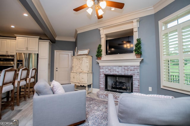 713 Birkdale Blvd, Carrollton, GA 30116 - living room with ornamental molding, a ceiling fan, a fireplace, light wood-style flooring, and recessed lighting