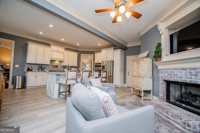 713 Birkdale Blvd, Carrollton, GA 30116 - living area featuring ornamental molding, a fireplace, ceiling fan, light wood-style flooring, and recessed lighting