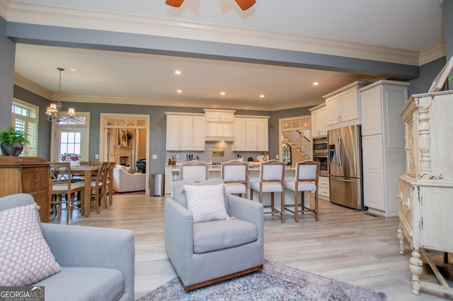 713 Birkdale Blvd, Carrollton, GA 30116 - living area with a chandelier, ceiling fan, light wood-type flooring, crown molding, and recessed lighting