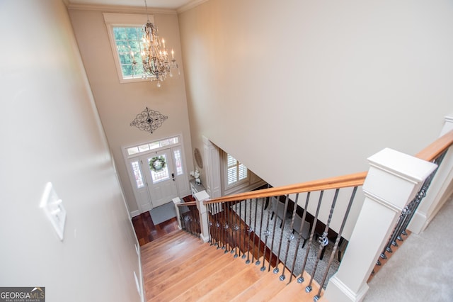 713 Birkdale Blvd, Carrollton, GA 30116 - entrance foyer featuring a chandelier, wood finished floors, stairway, crown molding, and a towering ceiling