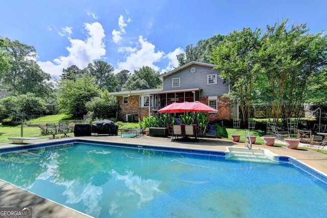 4562 Lucerne Valley Rd SW, Lilburn, GA 30047 - outdoor pool with a diving board and view of wooded area