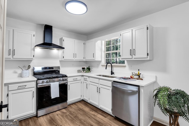 90 Lake Avalon Ct, Dallas, GA 30157 - kitchen with appliances with stainless steel finishes, wall chimney range hood, white cabinets, light countertops, and dark wood-style floors