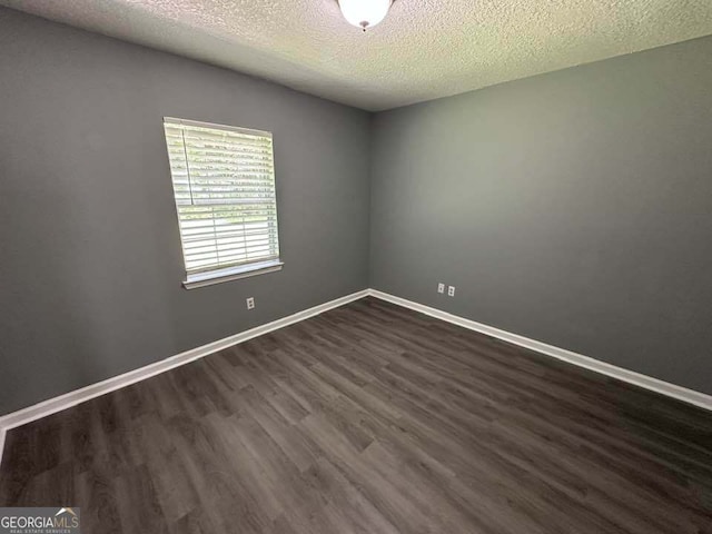 160 Lake Wellington Dr, Kingsland, GA 31548 - spare room with a textured ceiling and dark wood-style floors
