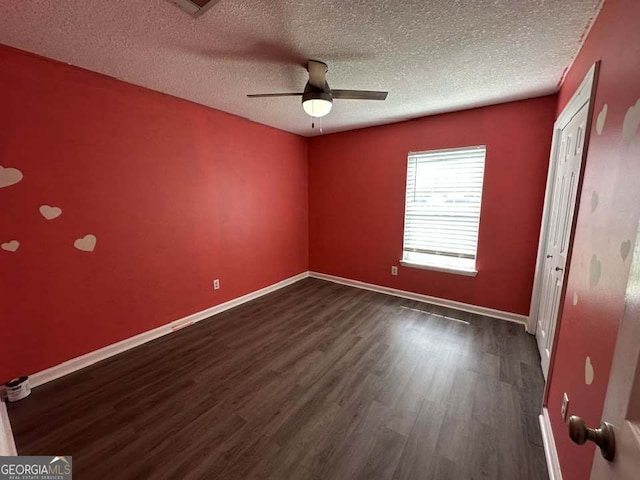 160 Lake Wellington Dr, Kingsland, GA 31548 - spare room featuring dark wood finished floors, a textured ceiling, and a ceiling fan