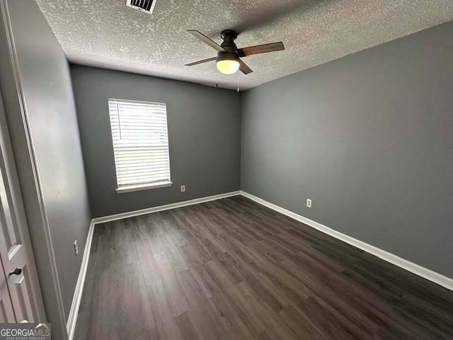 160 Lake Wellington Dr, Kingsland, GA 31548 - spare room featuring ceiling fan, dark wood-style flooring, and a textured ceiling
