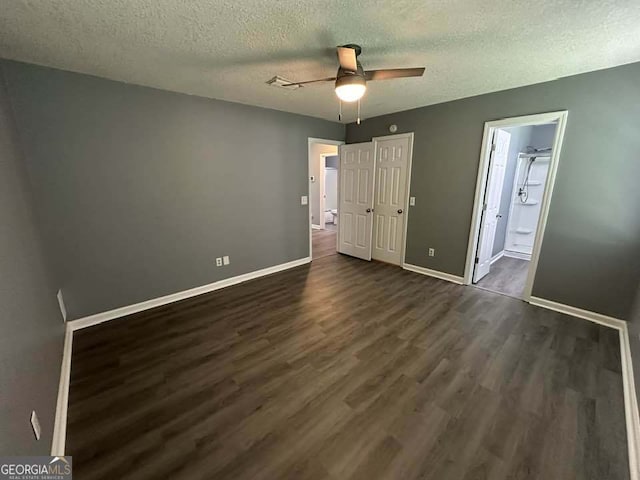 160 Lake Wellington Dr, Kingsland, GA 31548 - unfurnished bedroom with a textured ceiling, dark wood-style flooring, ensuite bath, and a ceiling fan