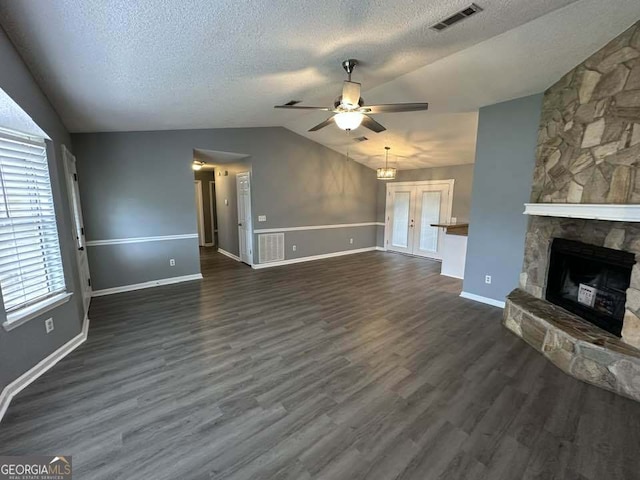 160 Lake Wellington Dr, Kingsland, GA 31548 - unfurnished living room featuring lofted ceiling, a ceiling fan, a fireplace, a textured ceiling, and dark wood-type flooring