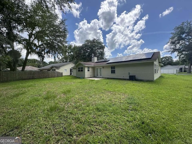 160 Lake Wellington Dr, Kingsland, GA 31548 - rear view of property with solar panels and french doors