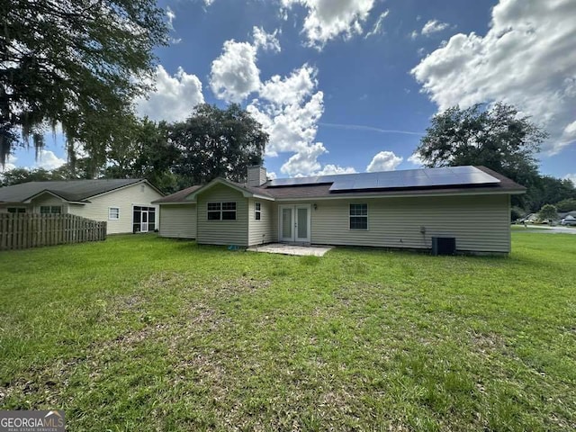 160 Lake Wellington Dr, Kingsland, GA 31548 - back of house with french doors, solar panels, a patio, and a chimney