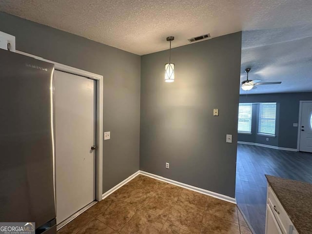 160 Lake Wellington Dr, Kingsland, GA 31548 - unfurnished dining area with a textured ceiling and ceiling fan