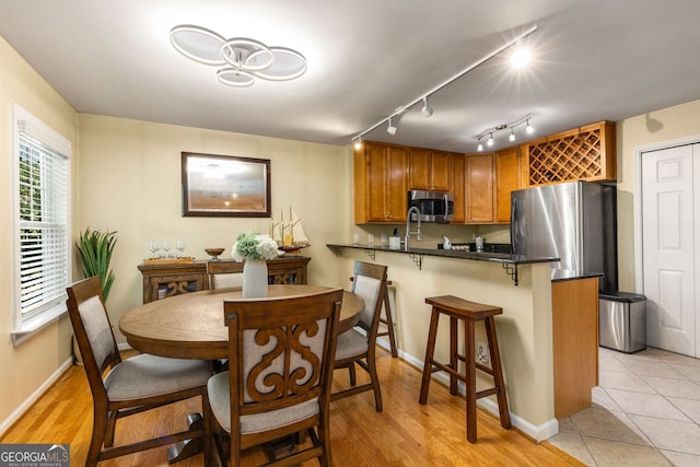 1445 Monroe Dr Unit 14B, Atlanta, GA 30324 - dining room featuring baseboards and light wood-style flooring
