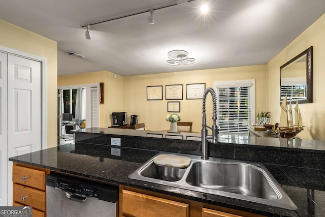 1445 Monroe Dr Unit 14B, Atlanta, GA 30324 - kitchen with stainless steel dishwasher, rail lighting, and brown cabinets