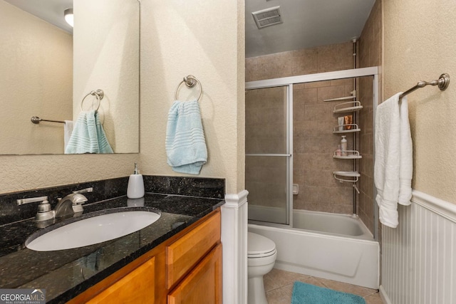1445 Monroe Dr Unit 14B, Atlanta, GA 30324 - bathroom featuring tile patterned flooring, vanity, enclosed tub / shower combo, and a textured wall