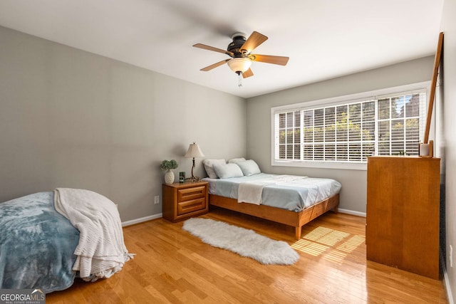 1445 Monroe Dr Unit 14B, Atlanta, GA 30324 - bedroom featuring wood finished floors, multiple windows, and a ceiling fan