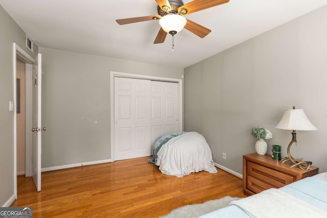 1445 Monroe Dr Unit 14B, Atlanta, GA 30324 - bedroom featuring wood finished floors, a closet, and a ceiling fan