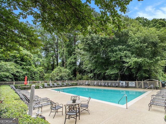 1445 Monroe Dr Unit 14B, Atlanta, GA 30324 - community pool featuring a patio area and view of wooded area