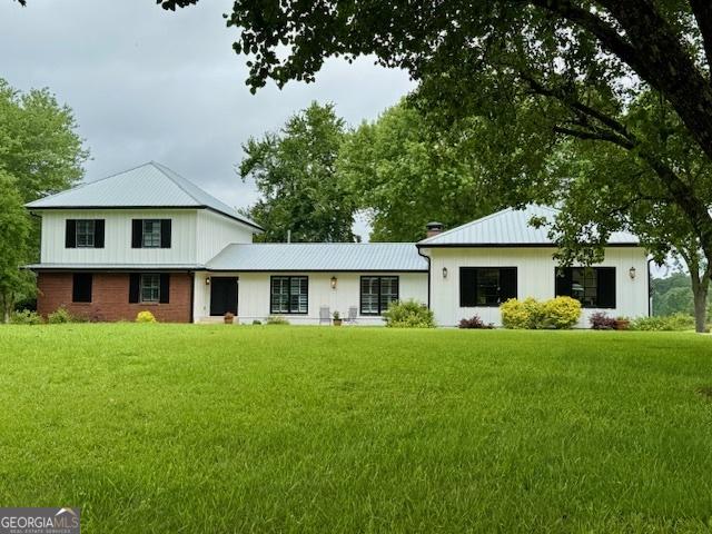 360 Morgan Mill Rd, Brooks, GA 30205 - modern inspired farmhouse featuring a front yard, a metal roof, and a standing seam roof