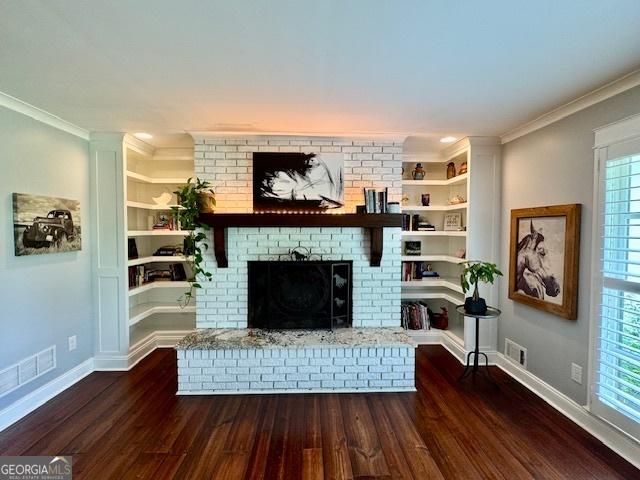 360 Morgan Mill Rd, Brooks, GA 30205 - living room with crown molding, wood finished floors, a fireplace, and built in shelves