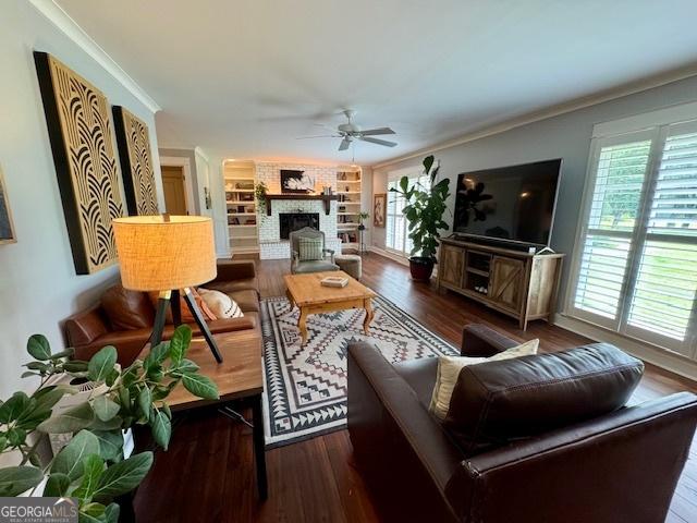 360 Morgan Mill Rd, Brooks, GA 30205 - living area featuring ceiling fan, wood finished floors, a fireplace, and ornamental molding